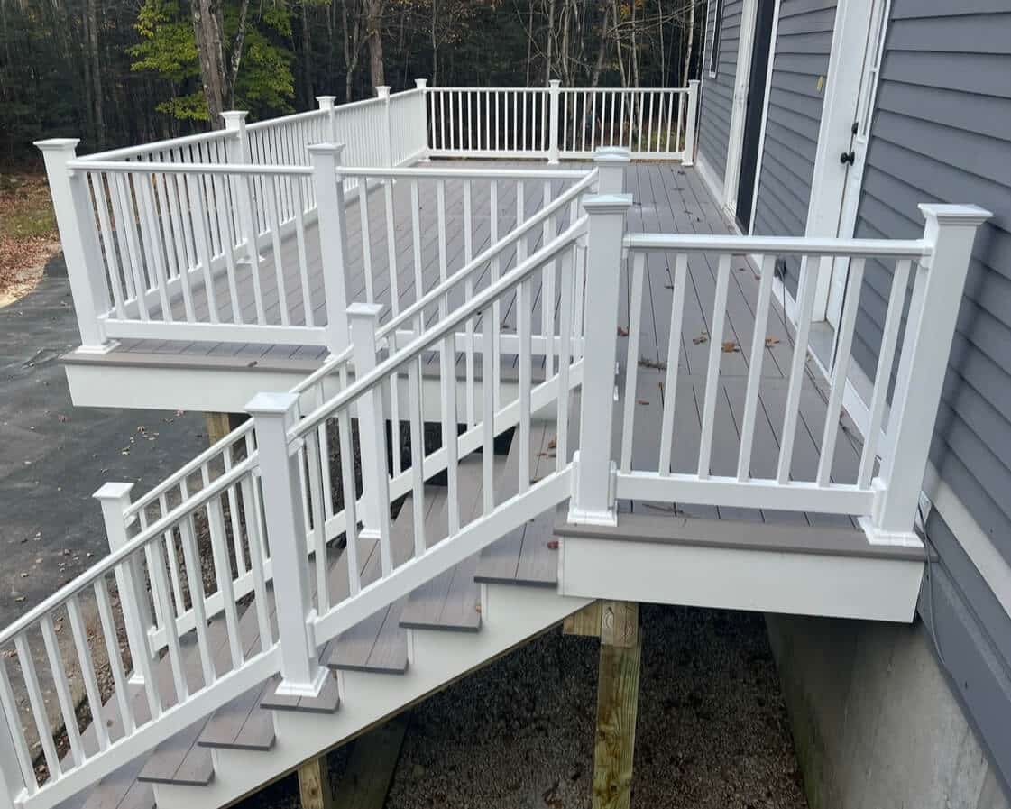 photo of a composite deck with white deck railing and deck steps