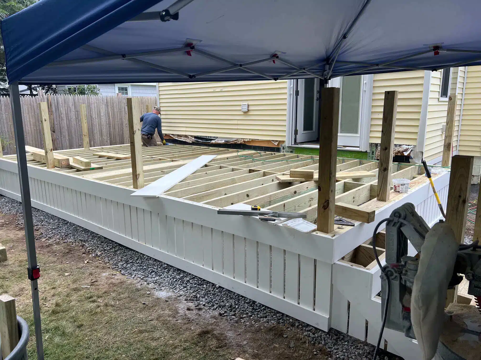 photo of a crew building a custom deck with composite deck materials and wood deck framing