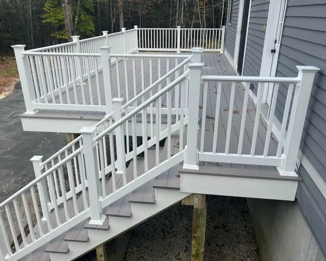 photo of elevated deck with white deck railing and deck steps