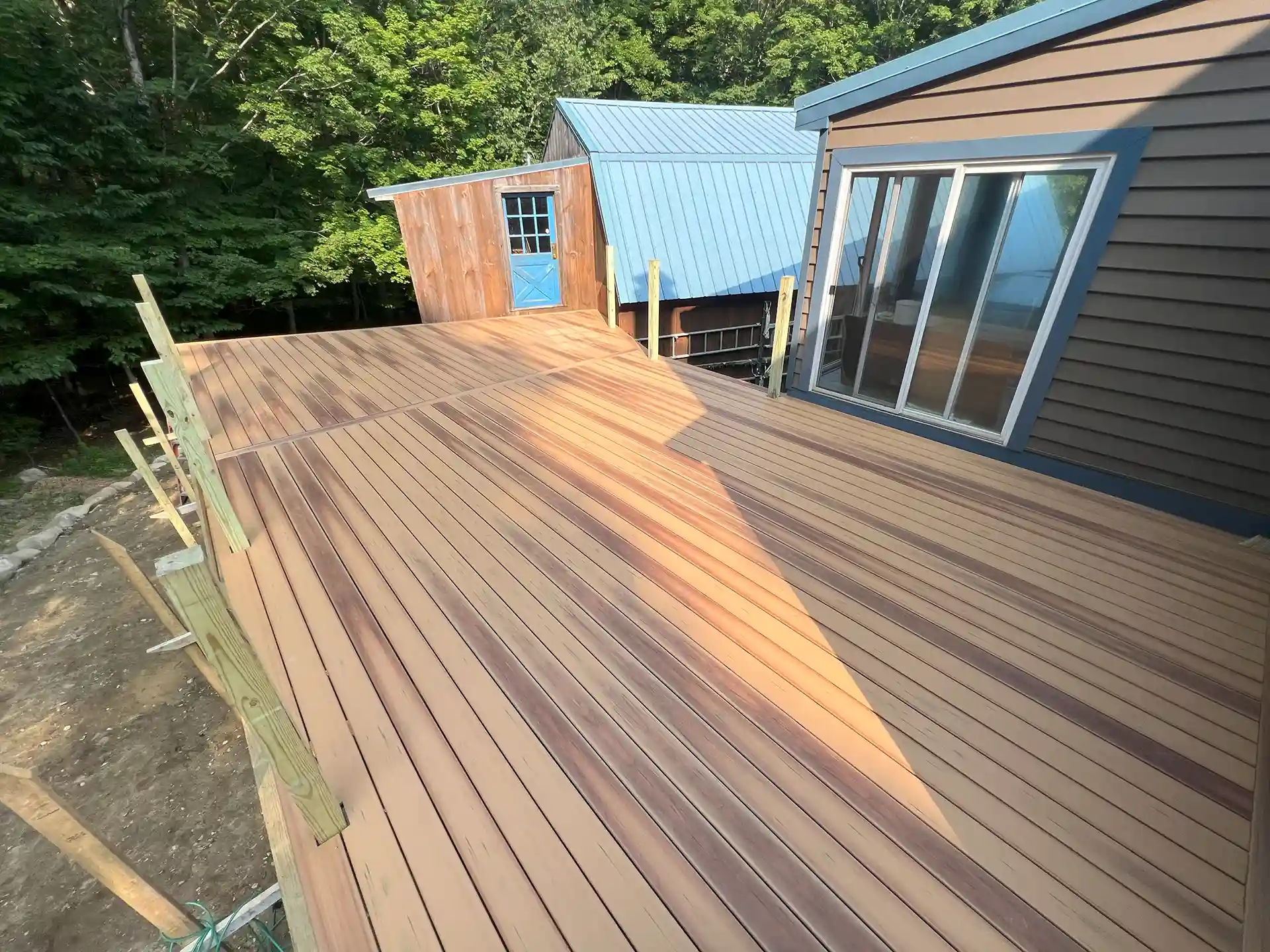 home with a deck being built with composite decking 
 - Deck-Remodeling-Services-and-Deck-Resurfacing-Contractors-in-East Kingston-NH