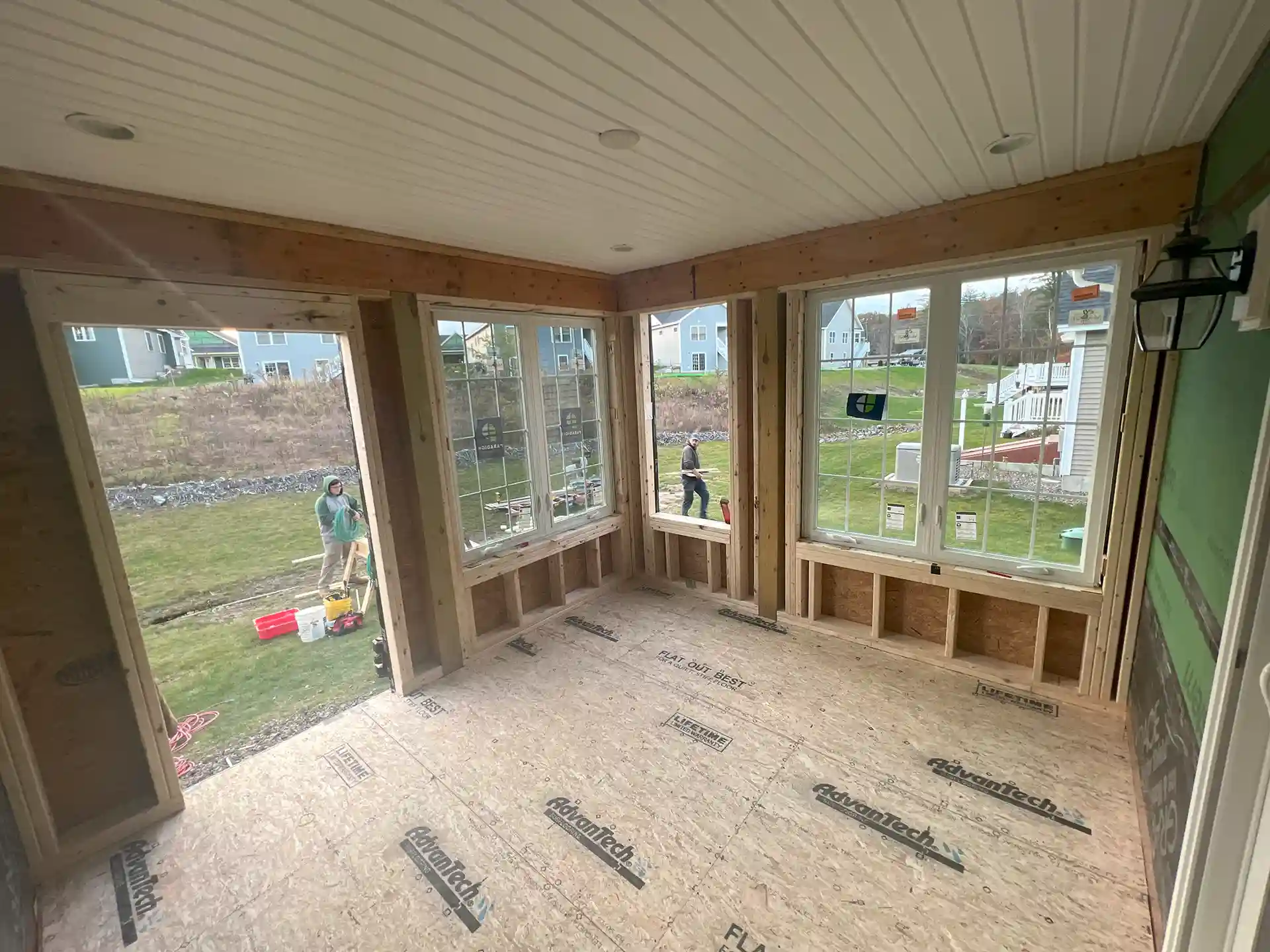 Crew building a covered porch with windows and solid roof  - Porch-Builder-Outdoor-Kitchen-contractors-Pergola-builders-in-East Kingston-NH