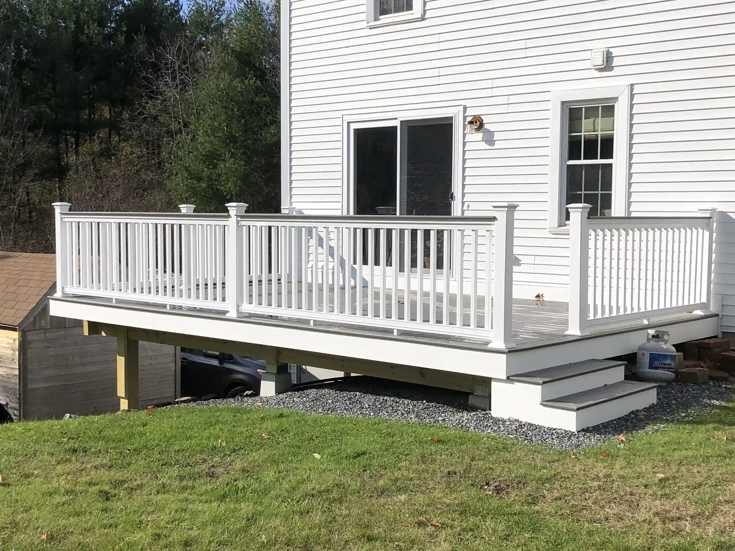 PHoto of a raised with custom deck showing a straight forward deck design idea