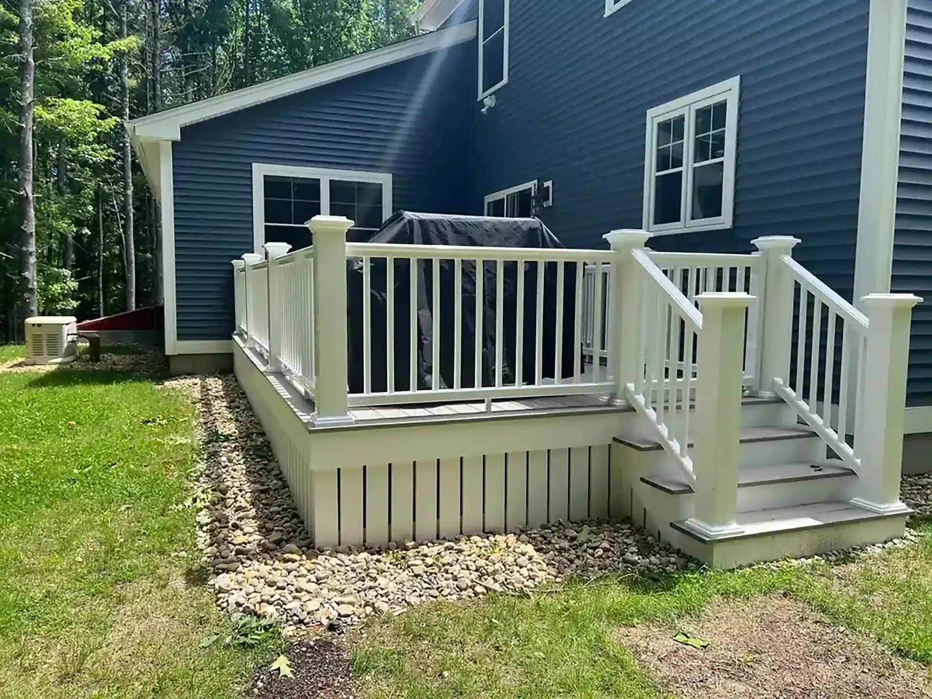 Photo of a custom deck with a grill deck area instead of a full outdoor kitchen from Allan Trant's Exterior Finish Work, outdoor kitchen builders in New Hampshire
