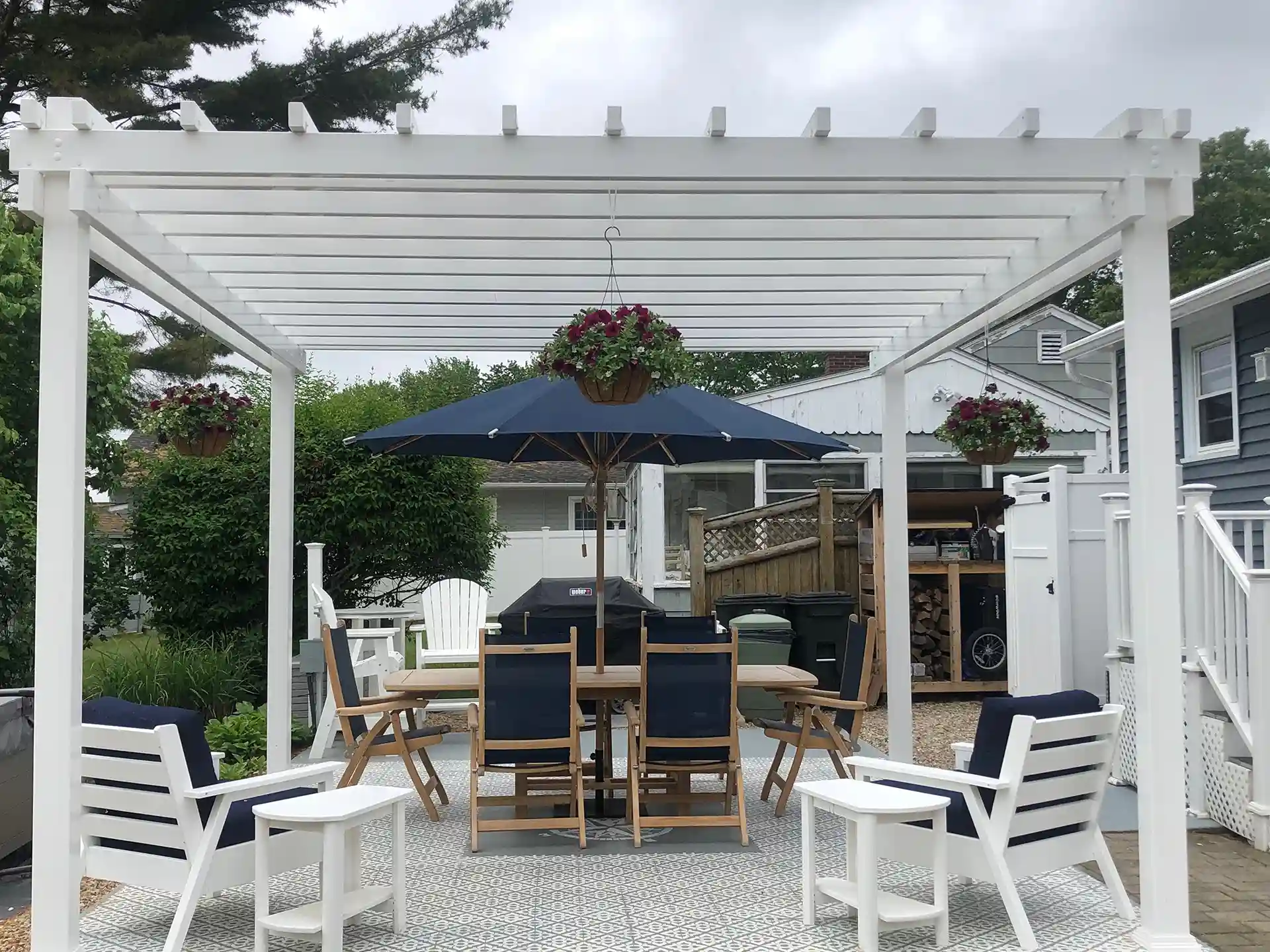 Photo of a pergola providing cover for a grilling station
